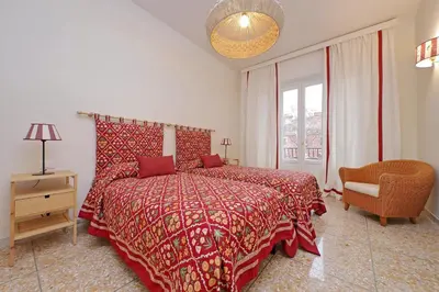 a bedroom with a bed and a chair and a window at Gioia's Home in Rome