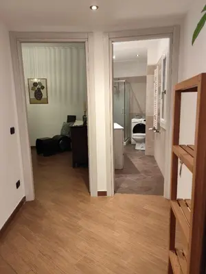 a room with a hallway with a bathroom and a room with a toilet at Next Stop St Peter - Apartment in Rome