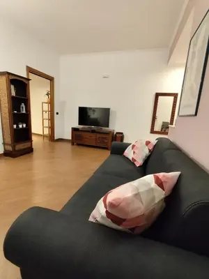 a living room with a couch and a flat screen tv at Next Stop St Peter - Apartment in Rome