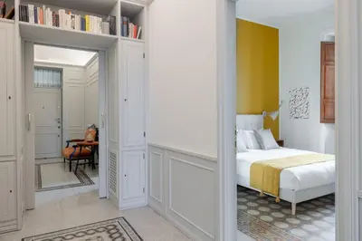 a bedroom with a bed and a mirror at Stylish 3BR between Vatican & City Center in Rome
