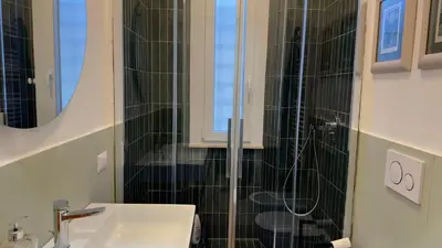 a bathroom with a sink and a shower at Elegant suite near the Vatican in Rome