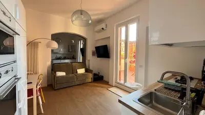a kitchen and living room with a couch and a sink at Elegant suite near the Vatican in Rome