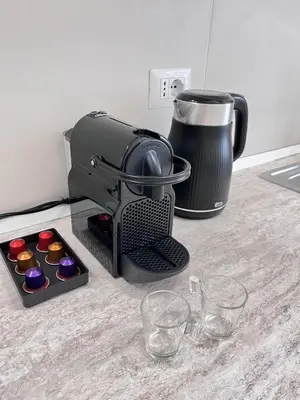 a mixer sitting on a kitchen counter with cupcakes at Parthenope Vatican House in Rome