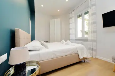 a white bedroom with a bed and a window at 4BNB - Flaminio Modern Apartment in Rome