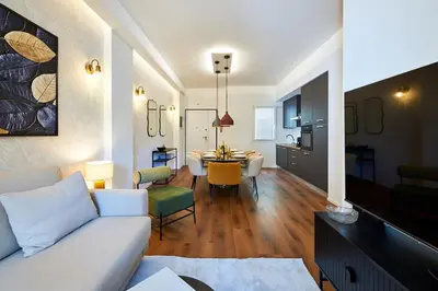 a living room with a white couch and a table at Art Suite San Giovanni in Rome
