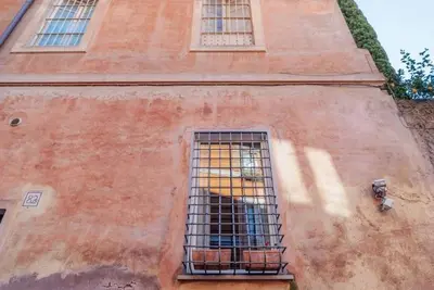 a tower with a barred window on a building at Residenza a Monti in Rome