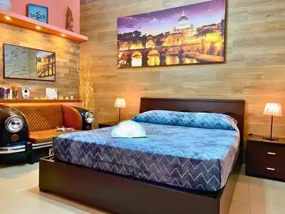 a bedroom with a bed and a chair and a couch at The Best Nest in Rome