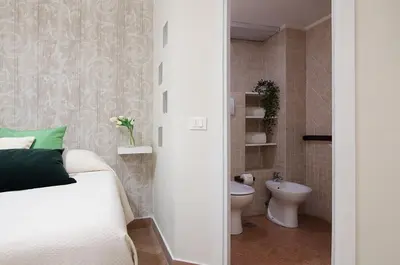 a small bathroom with a bed and a toilet at St Peter Vatican Lovely Apartment & Patio, Rome in Rome