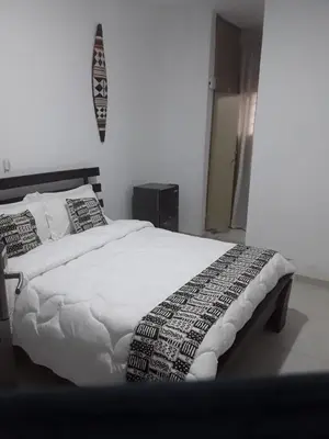 a bedroom with a bed with white sheets and pillows at Emmanuella Casa in Rome