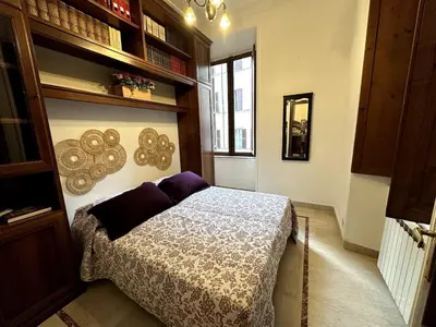 a bedroom with a bed with purple pillows at Borgo Pio Vatican in Rome