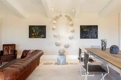 a living room with a couch and a table at Exclusive Home with pool and iconic View on Saint Peter in Rome