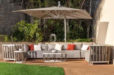 a couch and two chairs under an umbrella at Exclusive Home with pool and iconic View on Saint Peter in Rome
