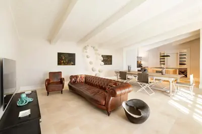 a living room with a leather couch and a table at Exclusive Home with pool and iconic View on Saint Peter in Rome