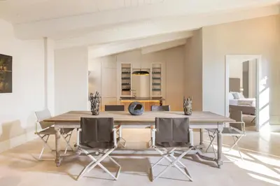 a dining room with a large wooden table and chairs at Exclusive Home with pool and iconic View on Saint Peter in Rome