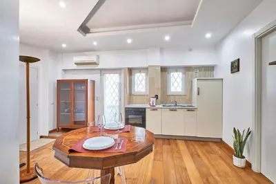 a kitchen with a table and chairs in a room at 2ND Level in Rome