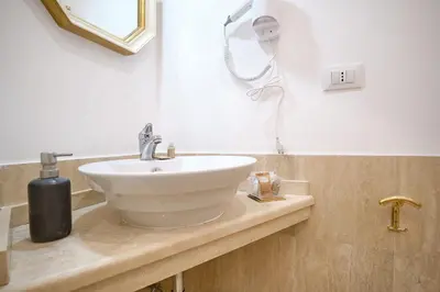 a bathroom with a sink and a blow dryer at 2ND Level in Rome