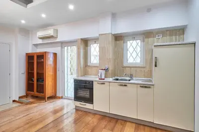 a kitchen with white cabinets and a sink at 2ND Level in Rome