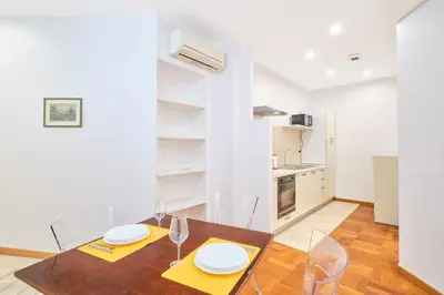 a kitchen and dining room with a table and chairs at 2ND Level in Rome