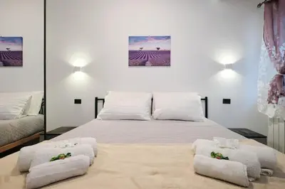 a bedroom with a bed with towels on it at 5 Cozy Pigneto Apt, Wifi & AC in Rome