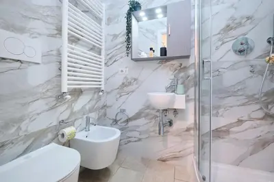 a bathroom with a sink and a toilet and a shower at 5 Cozy Pigneto Apt, Wifi & AC in Rome