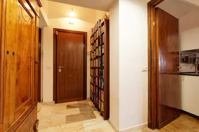 a hallway with a door and a book shelf at Le Note Di Angela in Rome