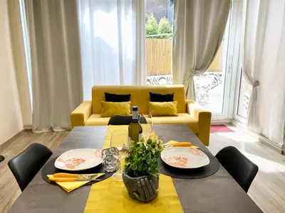 a living room with a table and a yellow couch at PIRAMIDE Romantic Home in Rome