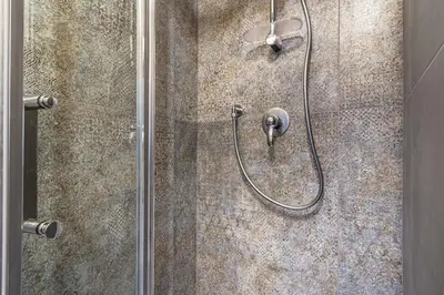 a shower with a shower head in a bathroom at St Peter Vatican- Stylish Apt, Roma in Rome