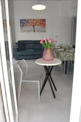 a vase of flowers on a table in a living room at SWEET RETREAT - Trastevere Station in Rome