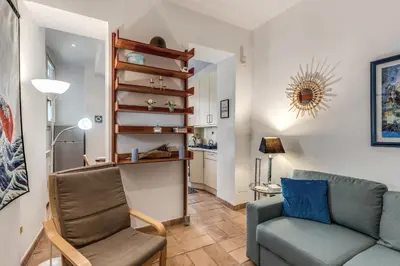 a living room with a couch and a chair at La Casa di Taumasia in Rome