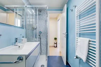 a bathroom with a white sink and a shower at Terrace with a view of Rome in Rome