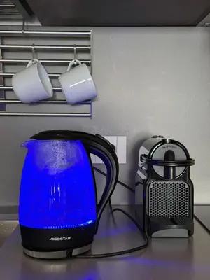 a blue kettle and a toaster on a counter at Labicum XXII - Modern Luxury Studio near the Colosseum in Rome
