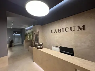 a lobby with a laburnum sign on the wall at Labicum XXII - Modern Luxury Studio near the Colosseum in Rome