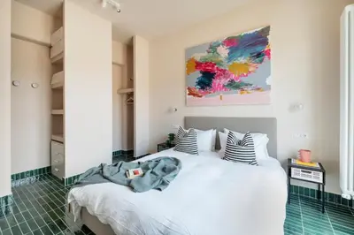 a bedroom with a white bed with striped pillows at Cipria Luxury Apartment in Rome