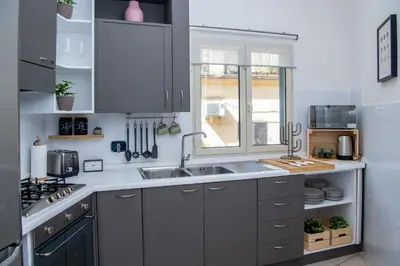a kitchen with a sink and a window at Piazza Navona Elegant Apartment in Rome