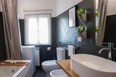 a bathroom with a tub and a toilet and a sink at Piazza Navona Elegant Apartment in Rome