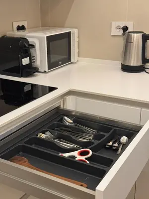 a drawer in a kitchen with a microwave and utensils at Re&x Home Rome Near Coloseum in Rome