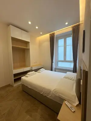 a bedroom with a large bed and a window at Re&x Home Rome Near Coloseum in Rome