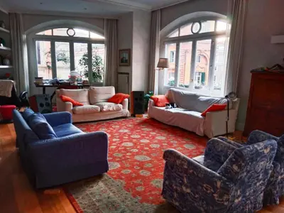 a living room with couches and a red rug at Private room by an Italian family - A unique experience close to Colosseum, the Roman Forum and Basilica Saint Mary Major in Rome