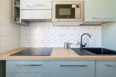 a kitchen with a sink and a microwave at Dolce Vita Penthouse in Rome