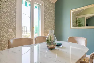 a white dining room with a white table and chairs at Dolce Vita Penthouse in Rome