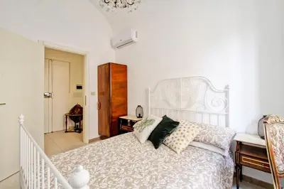 a bedroom with a white bed and a staircase at BigFamilyFlats - Colosseo&Monti - ROOMS in Rome