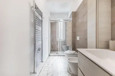 a bathroom with a tub and a toilet and a sink at Casa Malupa Luxury Apts San Giovanni in Laterano in Rome