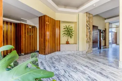 a lobby of a hotel with a potted plant at Casa Malupa Luxury Apts San Giovanni in Laterano in Rome