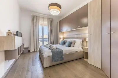 a bedroom with a large bed and a large window at Casa Malupa Luxury Apts San Giovanni in Laterano in Rome