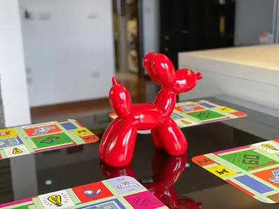 a red statue of two people on a table at 8bit Dreams - Al Pigneto - 100 m da Metro Malatesta in Rome
