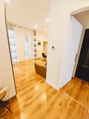 a living room with a couch and a wooden floor at La Dimora di Sara a 10 minuti da Termini in Rome