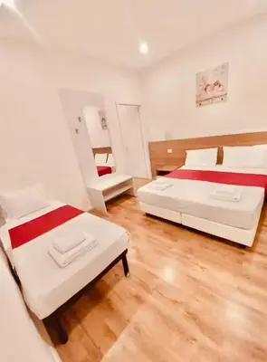 a bedroom with two beds and a mirror at La Dimora di Sara a 10 minuti da Termini in Rome