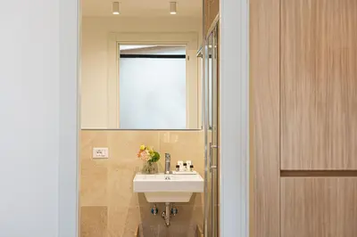 a bathroom with a sink and a mirror at Amazing Via del Corso 277 Suites in Rome