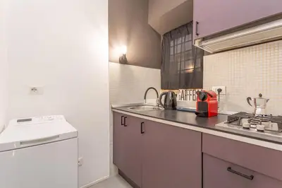 a small kitchen with a sink and a stove at Glam Nest & Garden Colosseum in Rome