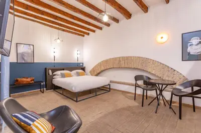 a bedroom with a bed and chairs in a room at Glam Nest & Garden Colosseum in Rome